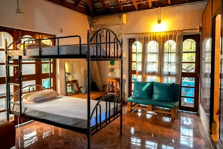 Cozy and affordable hostel room in Goa with bunk beds and natural light, ideal for budget travelers and backpackers
