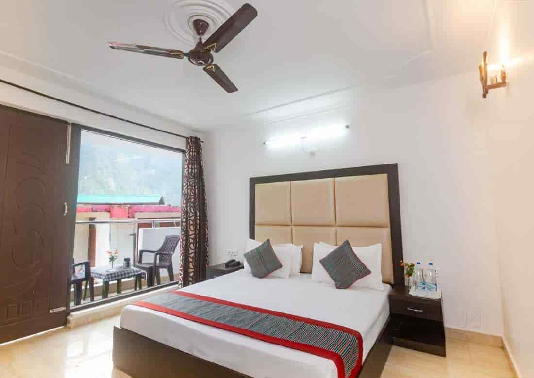 A clean and cozy room with balcony view in a budget hotel in McLeodganj, Dharamshala