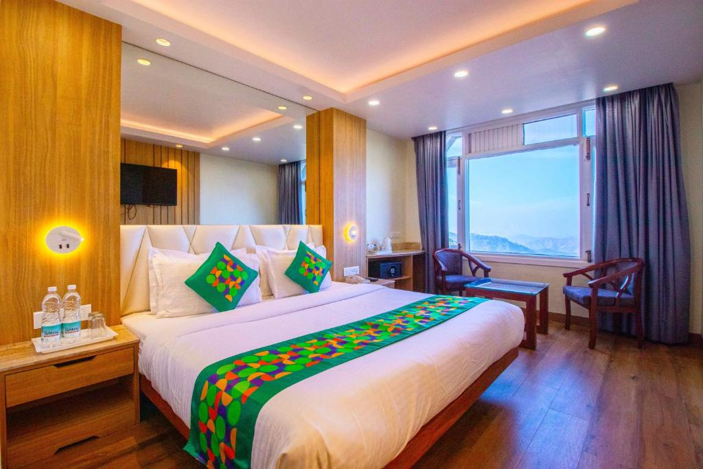 Bright and cozy budget hotel room with mountain view in Himachal Pradesh featuring modern amenities and seating by the window