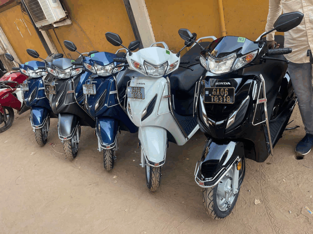 A lineup of Honda scooters available for rent, illustrating affordable transportation options for budget travelers in Goa