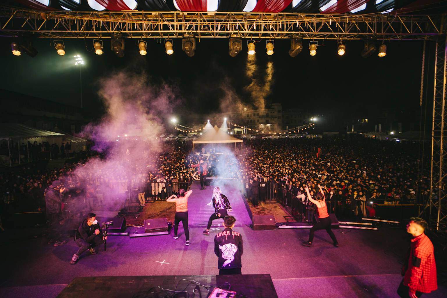 Nighttime music concert at Shillong Cherry Blossom Festival with a large enthusiastic crowd and dynamic stage performance