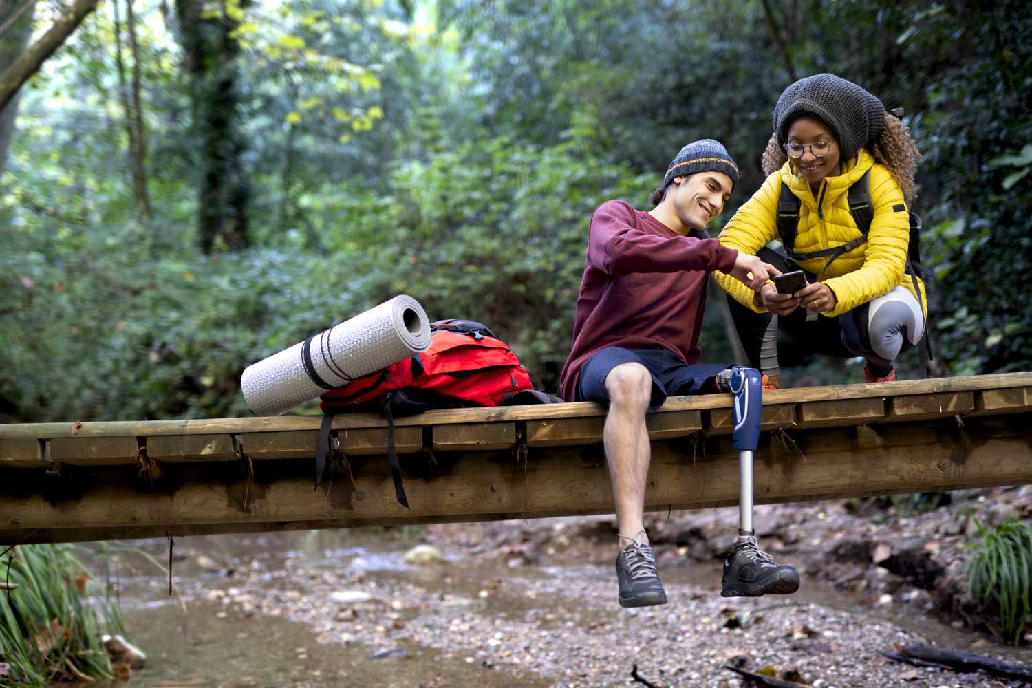 Young backpackers on a budget travel adventure in nature illustrate the need for suitable travel insurance plans including for travelers with disabilities