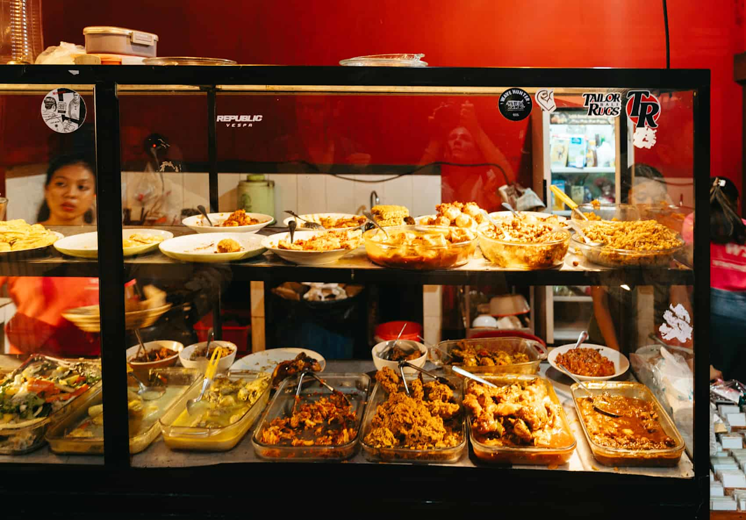 Variety of traditional Indonesian dishes served at a local warung food stall, showcasing budget-friendly authentic Balinese cuisine