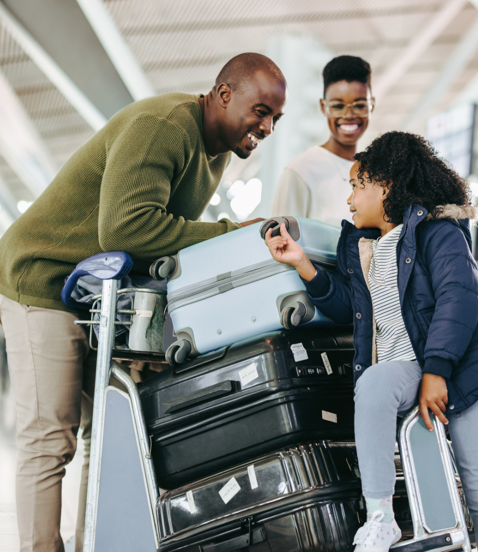 A family with luggage at an airport highlighting the need for travel insurance and baggage protection