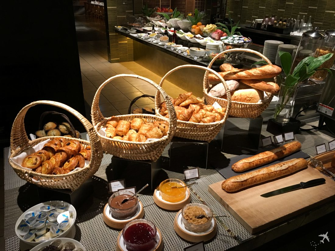 Hotel breakfast buffet featuring various breads and spreads as a cost-saving food option for travelers