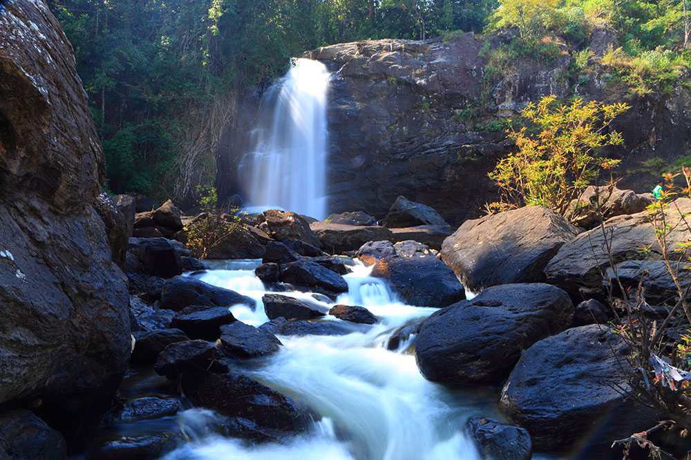 Soochipara Waterfalls in Wayanad, Kerala, showcasing the cascading water surrounded by lush rocks and greenery